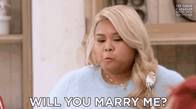 a woman says " will you marry me " while holding a spoon