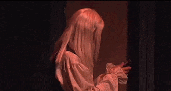 a woman in a pink wig says " well you didn 't text me back " to another woman