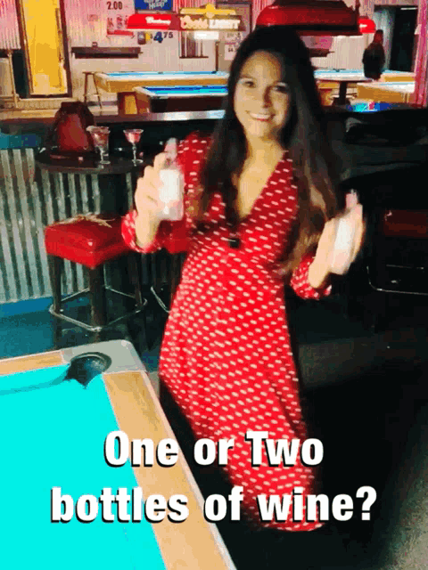 a woman in a red dress is standing in front of a pool table with the words one or two bottles of wine above her