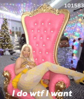 a woman is sitting in a pink chair that says " i do wtf i want " on it