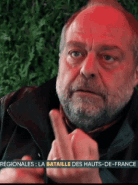 a man with a beard is giving the middle finger with the words regionales la bataille des hauts-de-france in the corner