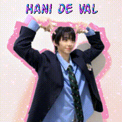 a man in a suit and tie making a heart with his hands