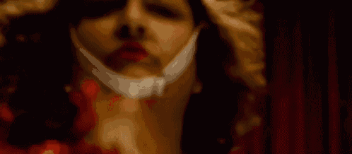 a close up of a person 's face with a bandage on it .