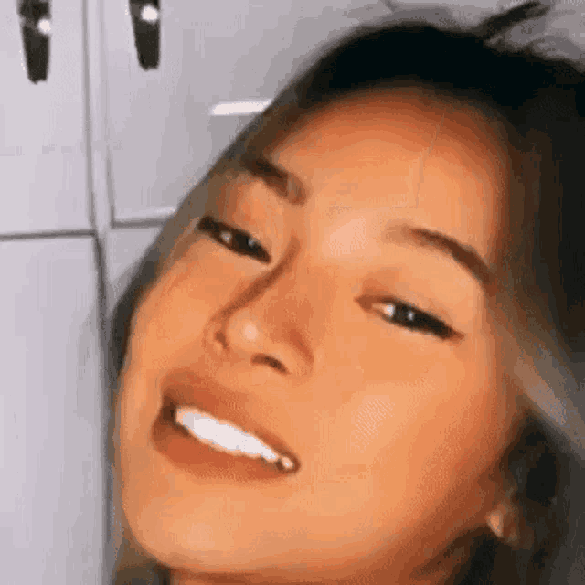 a close up of a woman 's face making a funny face with her mouth open .