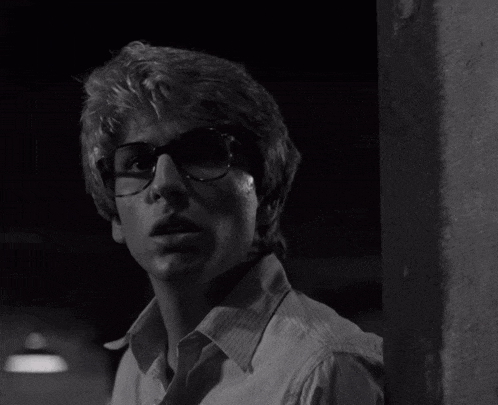 a black and white photo of a man with glasses
