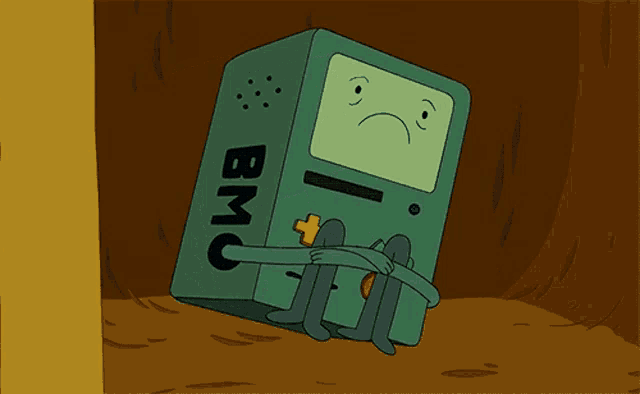 a cartoon character from adventure time is sitting on the ground with a sad face on his face .