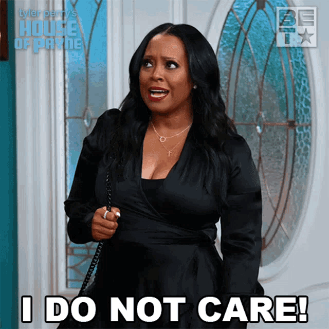 a woman says i do not care while standing in front of a window