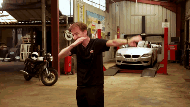 a man in a black shirt with a bmw logo on it