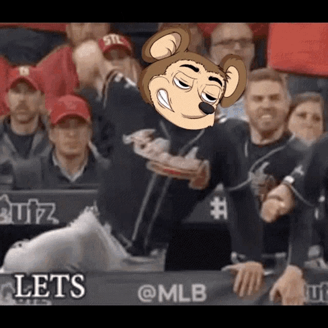 a baseball player is sitting in the dugout with a monkey head on his head .