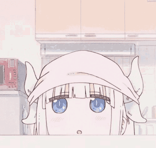 a girl with horns is wearing a pink hat and looking at the camera .