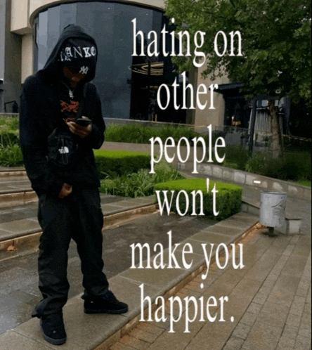 a man wearing a hoodie and a hat with the words hating on other people won 't make you happier written on it
