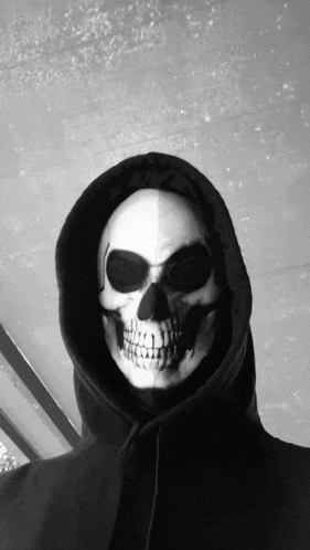 a black and white photo of a person with a skeleton mask on their face
