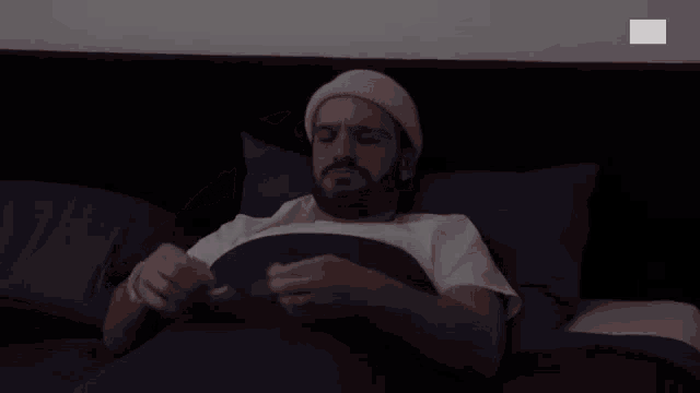 a man laying in bed with rts written on the bottom right