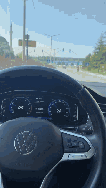 the steering wheel of a vw car shows that the speed is 6.6