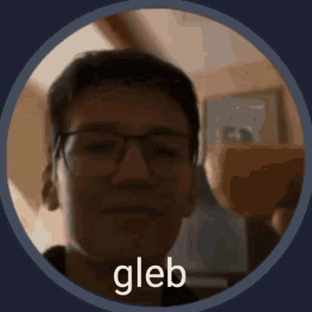 a close up of a man 's face with glasses and the word gleb on the bottom