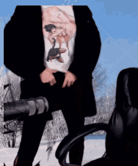 a man wearing a t-shirt with a picture of a deer on it