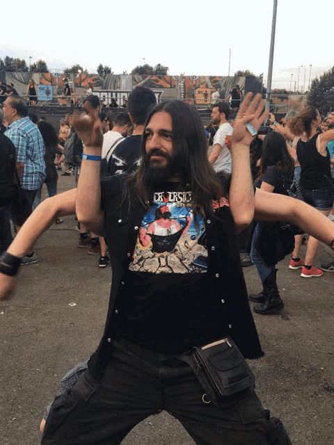 a man with long hair and a shirt that says jesus