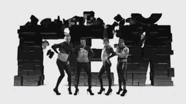 a group of people are standing in front of a brick wall that says ' tm ' on it