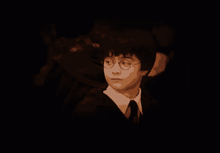 a close up of harry potter 's face in a dark room .