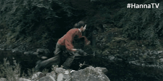 a person jumping off a rock in the woods with #hannatv
