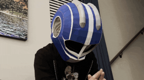 a man wearing a blue and white helmet with a hole in the middle