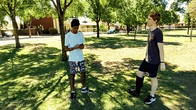 a man wearing a t-shirt that says ' ucsd ' on it stands next to another man
