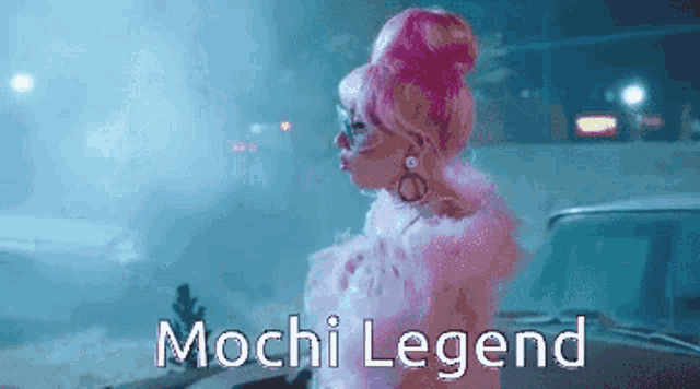 a woman in a pink wig is standing next to a car with the words mochi legend above her