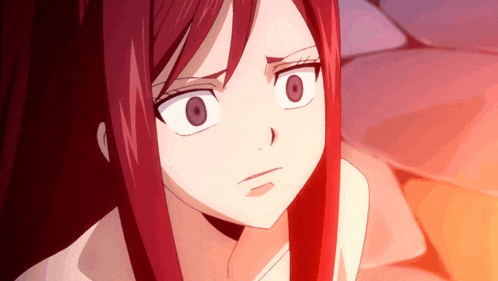a close up of a girl with red hair making a face