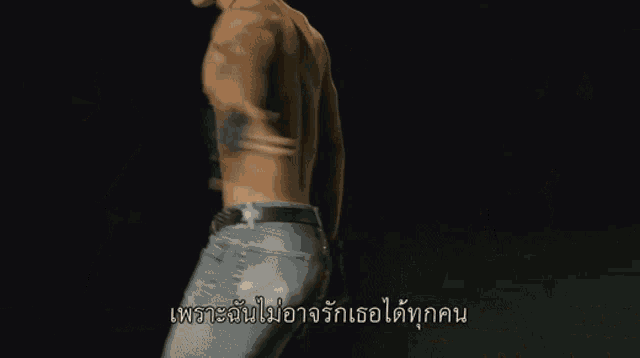 three men without shirts are standing on a stage in front of a sign that says ' thailand ' on it