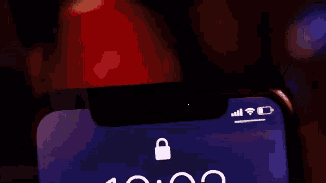 a close up of a cell phone displaying the time as 10:02