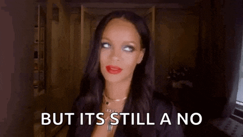 a woman with long black hair and red lips is standing in a dark room and says `` but it 's still a no ''