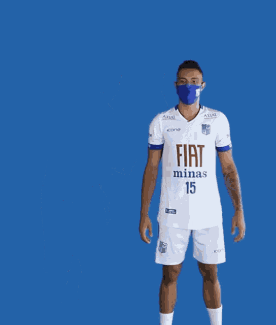 two soccer players wearing face masks and jerseys that say fiat minas