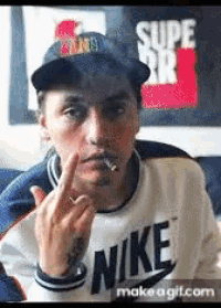 a man wearing a nike sweatshirt is smoking a cigarette and giving the middle finger