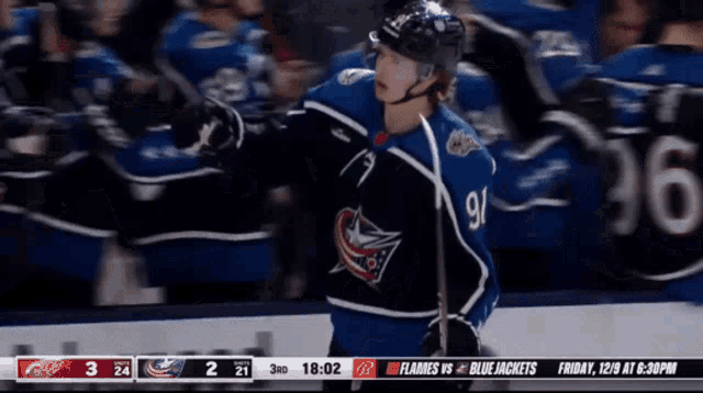 a hockey game is being played between the blue jackets and the flames
