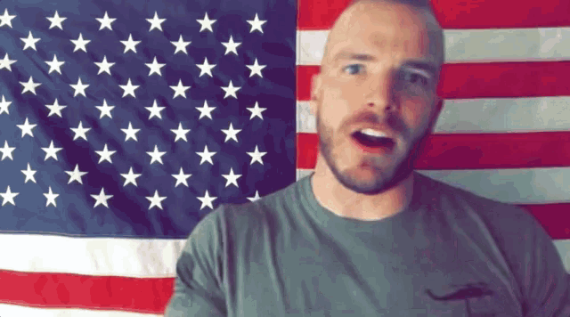 a man stands in front of an american flag with stars