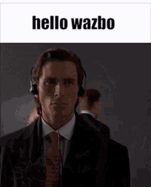 a man in a suit and tie is wearing headphones and says hello wazbo .