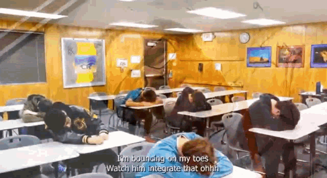 a group of people laying on their heads in a classroom
