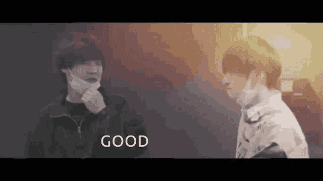 two men wearing masks are standing next to each other and the word good is on the bottom of the screen .