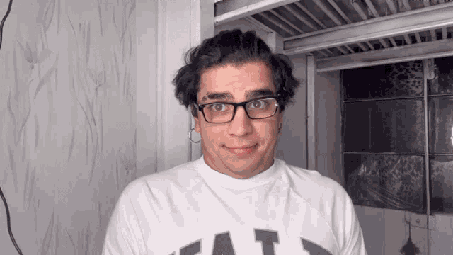 a man wearing glasses and a shirt that says eat