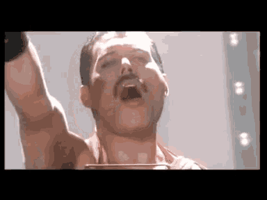 a close up of a man with a mustache screaming