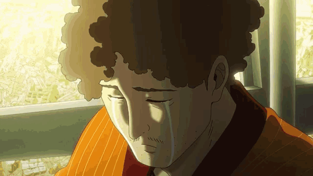 a man with curly hair is crying with a tear running down his face