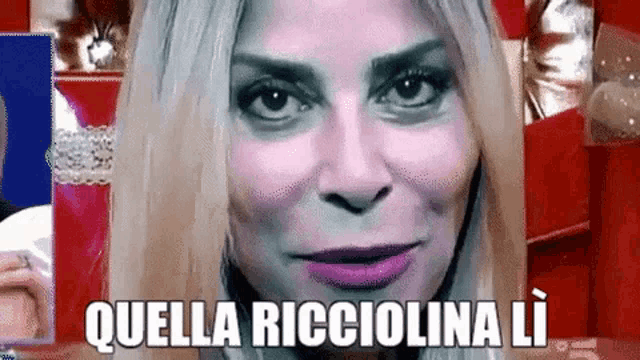a close up of a woman 's face with the words quella ricciolina li written on the bottom