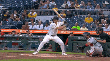 a baseball player getting ready to swing at a pitch in front of a pnc bank sign