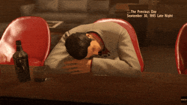a man laying on a bar with a bottle of jack daniels