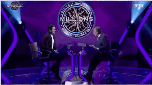a man in a suit and tie is giving a speech on a tv show