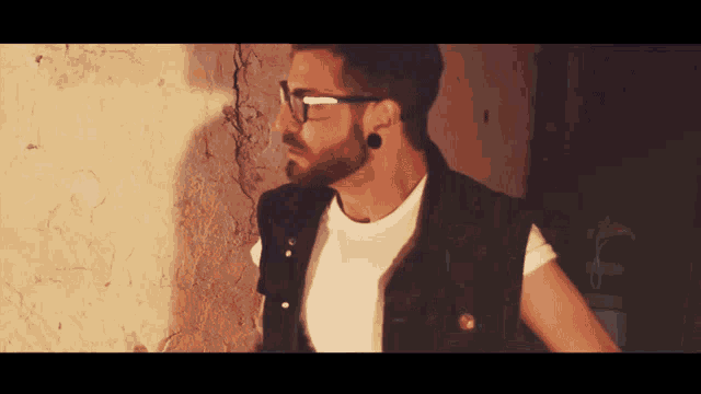 a man with a beard wearing glasses and a white shirt