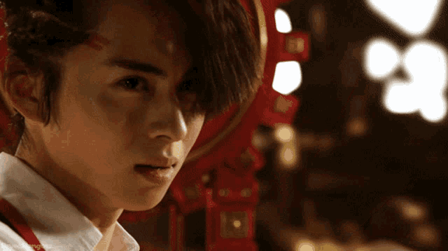 a close up of a person 's face with a red circle in the background that says ' chinese new year ' on it