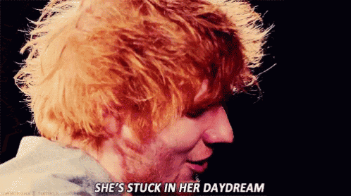 a close up of a person 's face with the words she 's stuck in her daydream
