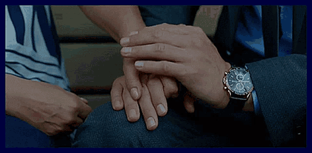 a man in a suit and tie holds a woman 's hand