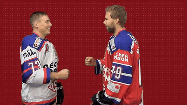 two hockey players shaking hands one of whom has the number 75 on his back